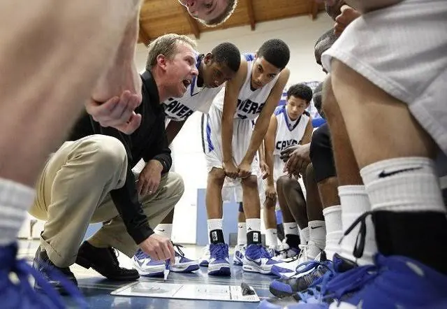 Ryan Irmer crouched in a timeout huddle, drawing up a play on a whiteboard for his San Diego High School basketball players.